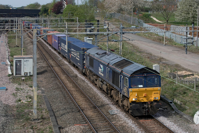 66305, 13.51 DIRFT-Ripple Lane (4L48, 3L), site of Roade station 
 On what had been a mainly grey day a rare bit of sunshine illuminates 66305 as it heads past the site of Roade station with the heavily laden 4L48 13.51 Daventry to Purfleet that, as is usual practice, was terminated at Ripple Lane. 
 Keywords: 66305 13.51 DIRFT-Ripple Lane 4L48 site of Roade station DRS Direct Rail Services