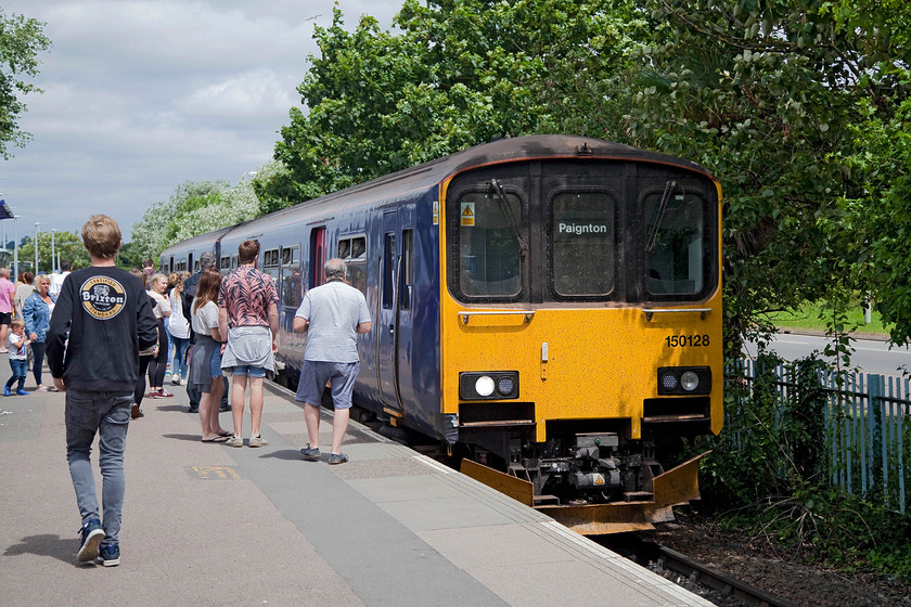 150128, GW 12.23 Exmouth-Paignton (2T15, RT), Exmouth station 
 I had bought a ticket, under guidance from a member of railway staff, from Exmouth to Lympstone Commando for Andy. In the picture, ticket in hand, Andy walks confidently to the train expecting to be able to alight at his chosen destination. However, when the train stopped at Commando station the guard would not allow him to alight even though he was going to get the next train straight back. After some discussion with the sentry on duty, during which Andy walked the length of the platform, he was ordered back on the train. Now, I was not happy about this, why sell a ticket to a station, with no warnings, that cannot be alighted at? I took this up with Great Western and then eventually the railway journalist Barry Doe took the case up. It is clear that clarification is needed, I hope that this is dealt with soon. Great Western issued pretty generic letter of apology along with a travel voucher. 
 Keywords: 150128 2T15 Exmouth station