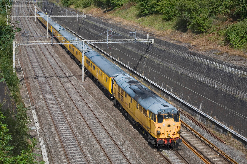 31233 & 31105, Hither Green-Derby RTC (3Z06), Roade cutting 
 The rear of the 3Z06 Hither Green to Derby RTC Network Rail test train passes through Roade cutting. It is remarkabale that these veteran Type 3s are still earning their keep on the modern railway but their time must surely be up soon with more modern motive power available. 
 Keywords: 31233 31105 Hither Green-Derby RTC 3Z06 Roade cutting NR Network Rail Test Train