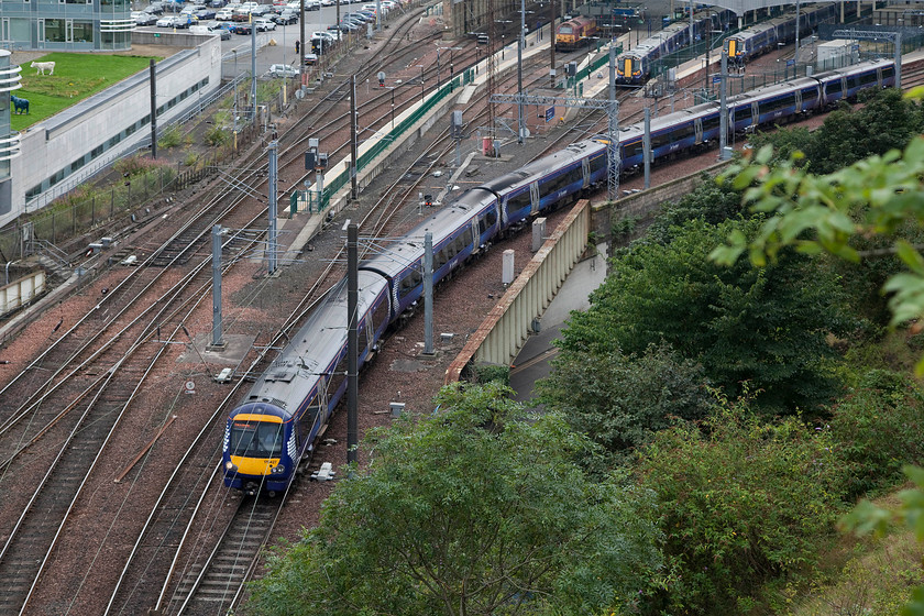 170247, SR 09.11 Edinburgh Waverley-Tweedbank (2T66), top of Jacob`s Ladder 
 170247 leads another unit out of Waverley station forming the 09.11 to Tweedbank. The image is taken from the top of Jacob's Ladder with the train about to enter Calton North tunnel. Notice the 'cows' grazing on the roof of the adjacent Edinburgh City Council building and car park to the far left. I suspect that they are made of a more modern and lighter material than famous Milton Keynes concrete examples that can be seen from the WCML. 
 Keywords: 170247 09.11 Edinburgh Waverley-Tweedbank 2T66 top of Jacob`s Ladder