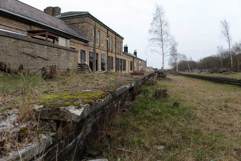 Former Woodhead platforms, Penistone station 
 The former platforms of the Woodhead route Penistone station are still clearly in view using this low angle shot. Whilst some of the edging stones are lifting the basic structure as built by the Great Central Railway is still largely intact. There are discussions about the partial reopening of the route for freight use, however, as the new Woodhead tunnel bores are now in-use for other purposes this is looking rather more unlikely. 
 Keywords: Penistone station