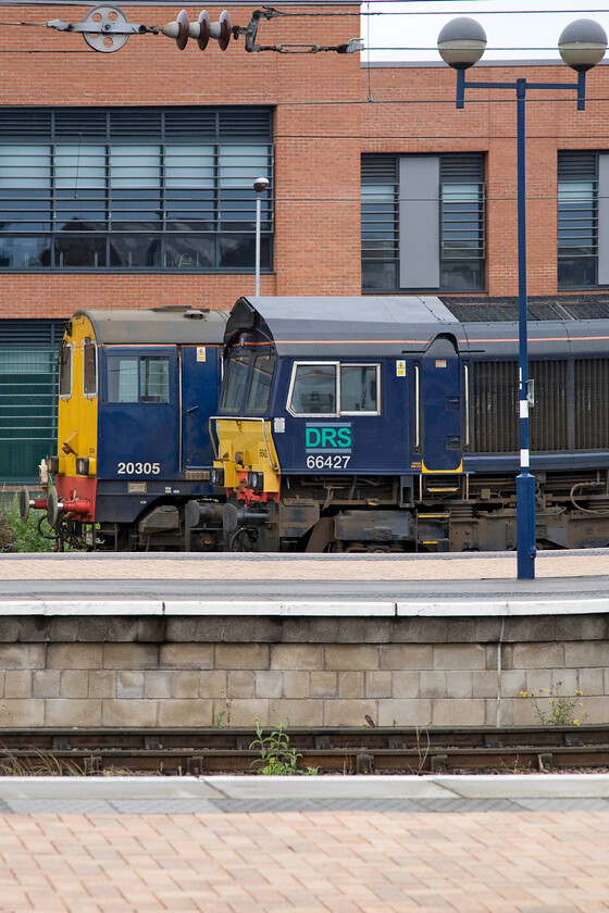 20305 & 66427, stabled, York Parcel Sidings 
 I was half expecting some English Electric action on this particular morning at York station as 20305 was sitting in York's Parcel Sidings with its engine running. However, it stayed firmly sandwiched between 66427 and the York signalling centre during the hour or so that I was at the station. 
 Keywords: 20305 66427 stabled York Parcel Sidings