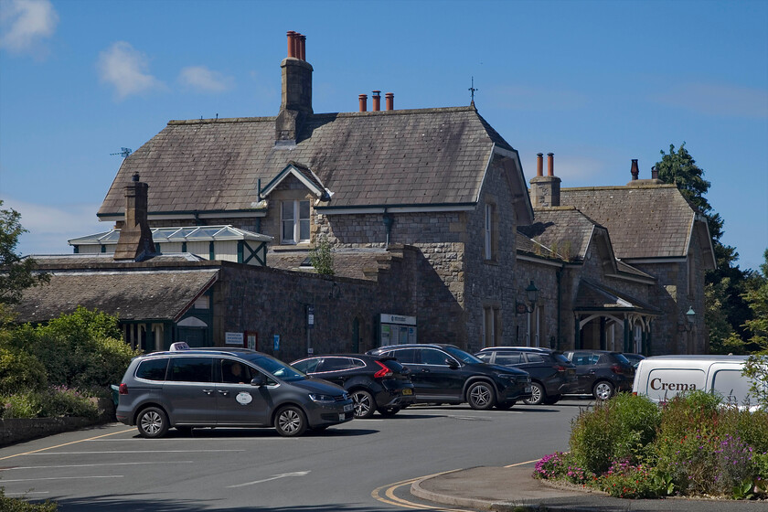 Frontage, Grange-over-Sands station 
 Grange station, as was known until renamed by the LMS in 1930, is a large building designed and built by the Furness 1864 designed by local architect E. G. Paley. The Grade II listed station is in super condition and is well patronised but I did notice that its passenger numbers have dropped a little in the latest data released. A note to future visitors, there is no free twenty-minute parking or even a drop-off point at the station. Andy and I were forced to park on a nearby road with an hour limit. 
 Keywords: Frontage, Grange-over-Sands station