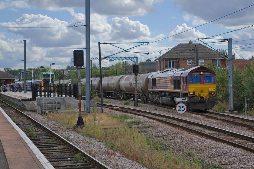 66230, 12.16 Rectory Total Sidings-Lindsey Oil Refinery (6E82), Grantham station 
 Having run round the rake of tankers 66230 gets the train underway again continuing its journey, now northwards, along the ECML. The train is the 6E82 12.16 Rectory Sidings (Total) to Lindsey oil refinery empty tankers today hauled by 66230. Once on the ECML the train will have to get a move on to avoid faster trains backing up behind it making use of the numerous loops between here and Doncaster to give others a chance to pass. 
 Keywords: 66230 12.16 Rectory Total Sidings-Lindsey Oil Refinery 6E82 Grantham station EWS