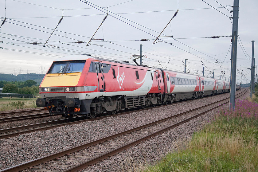 91127, GR 08.35 London Kings Cross-Leeds (1D06, RT), Sandy TL176510 
 For an electric locomotive, the class 91 makes a lot of noise. They really roar when they pass and I love their chime horns that sort of evoke the Gresleys that used to race up and down this line. 91127 shatters the peace at New Zealand bridge just north of Sandy with the 08.35 King's cross to Leeds. 
 Keywords: 91127 1D06 Sandy TL176510