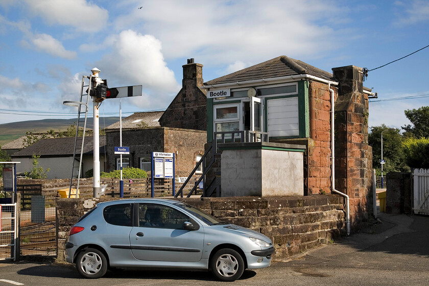 Bootle signal box (Furness, 1871) 
 Viewed from the rear Bootle signal box reveals its obvious Furness heritage. The box dates from 1871 and controls a level crossing as well as a suite of semaphore signals including the down starter seen behind the signalman's car. 
 Keywords: Bootle signal box Furness Railway