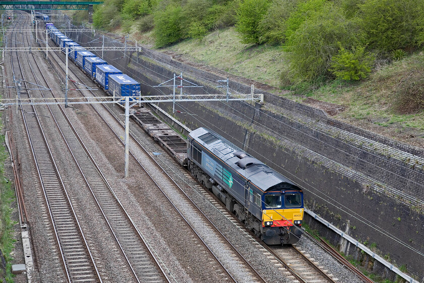 66433, 11.16 DIRFT-Tilbury (4L48), Roade cutting 
 DRS' 66433 leads an almost pedestrian 4L48 Stobart 11.48 Daventry yo Tilbury service through Roade cutting. This daily service (seven days per week) is operated on behalf of Tesco with products bot imported and exported from their giant DIRFT distribution centre. 
 Keywords: 66433 11.16 DIRFT-Tilbury 4L48 Roade cutting Direct Rail Services DRS