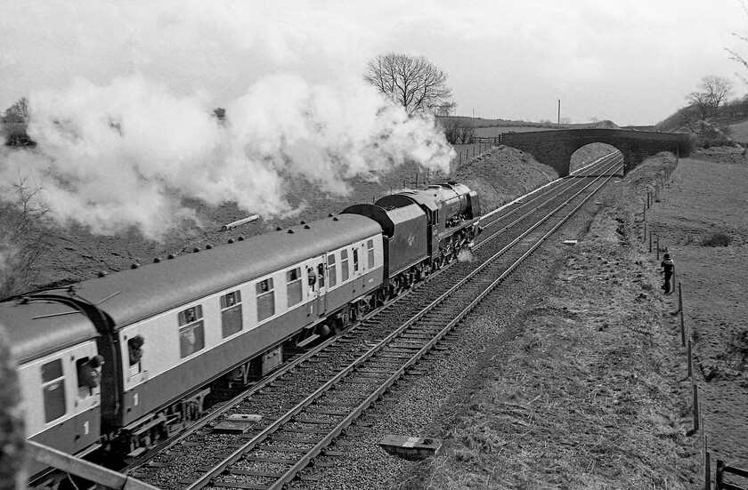 46229, outward leg of The Cumbrian Mountain Express, Carlisle-Hellifield, Keld NY675227 
 As going-away photographs go this one is pretty good! I like the motion blur evident in the leading coaches along with the slightly backlit and reflective lighting on 46229 'Duchess of Hamilton' and its exhaust. It is leading the outward leg of The Cumbrian Mountain Express past the hamlet of Keld just north of Appleby. Before the last coach of the train had even passed we were all back in the Austin 1100 and the race was on! 
 Keywords: 46229 The Cumbrian Mountain Express Carlisle-Hellifield Keld NY675227 LMS Princess Coronation Class Duchess of Hamilton