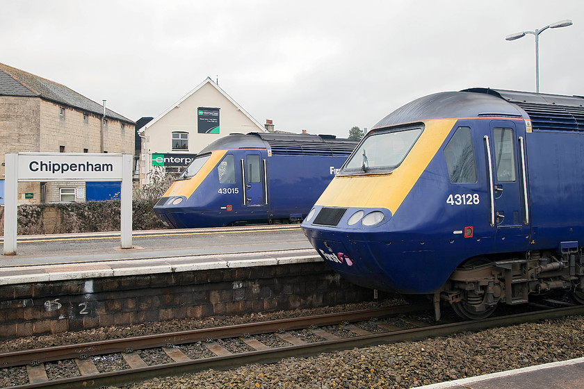 43015, GW 13.00 Bristol Temple Meads-London Paddington (1A18, RT) & 43128, 12.00 London Paddington-Bristol Temple Meads (1C13, 6L), Chippenham station 
 A meeting of HSTs at Chippenham station. 43015 (ex. 253007) waits at the rear of the 13.00 Bristol Temple Meads to London Paddington whilst 43128 (ex. 253029) is at the front of the 12.00 Paddington to Bristol. This is a scene soon to disappear from this and all spots along the GWML; a scene that we have all become so familiar with! 
 Keywords: 43015 1A18 43128 1C13 Chippenham station