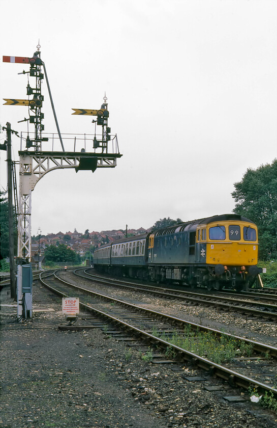 33062, 08.20 Brighton-Cardiff Central (1V22), Salisbury East Yard 
 The 08.20 Brighton to Cardiff Central 1V22 Saturday service approaches Salisbury through the East Yard led by 33062. Despite the abandonment of four-character headcodes by BR in 1975, much to the chagrin of the enthusiast, the Southern Region continued with the use of their unique two-character version. 33062 is wearing the correct 99 identifier suggesting correctly that it was a 'Brighton-Bristol Temple Meads via Southampton and Salisbury' service*.

* thanks to the Southern Railway Email Group for this information 
 Keywords: 33062 08.20 Brighton-Cardiff Central 1V22 Salisbury East Yard Crompton