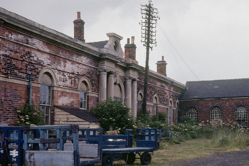 Former frontage, New Holland Town station 
 The former frontage of New Holland Town station is seen now in a pretty sorry state with all access now via the platform end. The former car park at the front is now grassed over and used for storage as seen here. Notice the hole in the stonework above the entrance that would once have housed a station clock. The rather grand station was opened by the Manchester, Sheffield, and Lincolnshire Railway in 1848 but was to close completely just a week after this photograph was taken. Unfortunately, it did not survive and was demolished with the site now occupied by industrial premises. 
 Keywords: Former frontage New Holland Town station