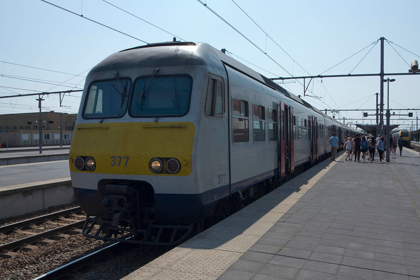 83377, 09.22 Hasselt-Blankenberge (EXT 18332), Brugges station 
 Unfortunately, taken directly into the sun but as it was the train we travelled on I have included it. 83377 waits at Brugge station working the 09.22 Hasselt-Blankenberge (EXT 18332). We travelled on this unit from Brussels Centraal and a very comfortable ride it was too. Despite these class AM83s being some 35 years old they are reliable and fast units with many remaining in front-line service with the earliest examples introduced in 1980. 
 Keywords: 83377 09.22 Hasselt-Blankenberge EXT 18332 Brugges station