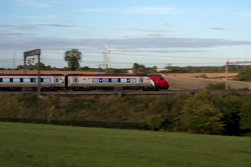 Class 221, VT 18.23 London Euston-Shrewsbury (9J38, 9L), Roade Hill 
 An unidentified class 221 Voyager heads north forming the 18.23 Euston to Shrewsbury. This pan shot is taken on Roade Hill between the villages of Roade and Ashton just south of Northampton. The sun should have been out to illuminate the train but a small and stubborn bank of cloud prevented this where all around was blue sky as per in the background! 
 Keywords: Class 22 18.23 London Euston-Shrewsbury 9J38, Roade Hill