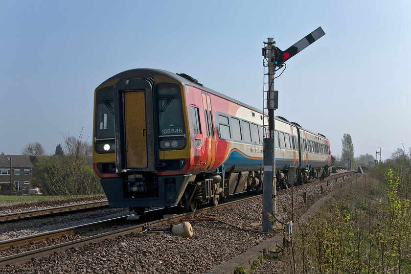 158856, EM 08.54 Norwich-Liverpool Lime Street (1R66, 7L), Harts Drove crossing TL273962 
 A little side-lit but I like this study as it includes a semaphore! 158856 works the 08.54 Norwich to Liverpool train past Wittlesey's Harts Drove crossing. This is one of the few of these EMT cross country services that works through rather than stopping and connecting at Nottingham, very much seen as a retrograde step. By this stage, a number of photographers had gathered at this well-known spot for the main feature coming along soon! 
 Keywords: 158856 08.54 Norwich-Liverpool Lime Street 1R66 Harts Drove crossing TL273962 East Midlands Trains EMT