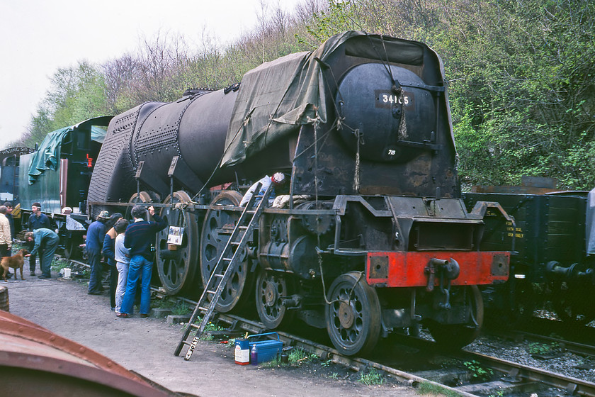 34105, undergoing restoration, Ropley Yard 
 In the yard at Ropley station Bulleid Pacific 34105 'Swanage' undergoes its first restoration after being saved from Barry in March 1978. It would take the dedicated band of volunteers another seven years to get the locomotive in steam again with it entering service here on the Mid-Hants Line in 1987. 'Swanage' became a regular on the preserved line for ten years until it required another overhaul. This was undertaken and the locomotive entered service again that included it visiting other lines such as the Gloucestershire and Warwickshire Railway. At the time of writing in 2020 it was approaching the end of yet another complete overhaul but this time, unlike the open-air photograph, it would be inside one of the Mid-Hants Railway's large sheds. 
 Keywords: 34105 undergoing restoration Ropley Yard Swanage Mid Hants. Railway Watercress Line