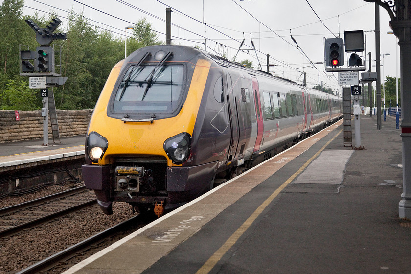 221139, XC 17.08 Edinburgh Waverley-Birmingham New Street (1M80, 9L), Morpeth station 
 221139 passes at line speed through Morpeth station forming the 17.08 Edinburgh to Birmingham New Street service. Its next stop will be Newcastle Central in some sixteen miles time. Notice signal M123 with three feathers sprouting off the top indicating to freight drivers which route they are going to take when leaving the mainline to enter the freight network of Blyth and Ashington. There is also a lower feather for access to the refuge siding just north of the station. 
 Keywords: 221139 17.08 Edinburgh Waverley-Birmingham New Street 1M80 Morpeth station