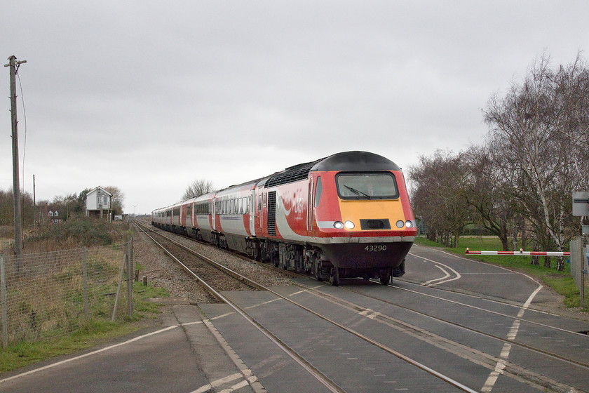 43290, GR 08.55 Newcastle-London Kings Cross (1Y20, 11L), Three Horse Shoes no.1 level crossing 
 I deliberately chose to frame the train a little earlier than would normally be the case here. I wanted the AHB crossing to be in the image as I suspect that these are an endangered species given the number of incidents that seem to take place on them. This particular one had recently been upgraded. The usual high pitched siren had gone and a much less piercing one installed that is broken up with a digital message stating 'warning, another train is approaching'. The HST is led by power car 43290 working the 08.55 Newcastle to London King's Cross. Note; Three Horse Shoes signal box in the middle distance and a couple of its sole remaining, but out of use, telegraph poles. 
 Keywords: 43290 08.55 Newcastle-London Kings Cross 1Y20 Three Horse Shoes no.3 level crossing