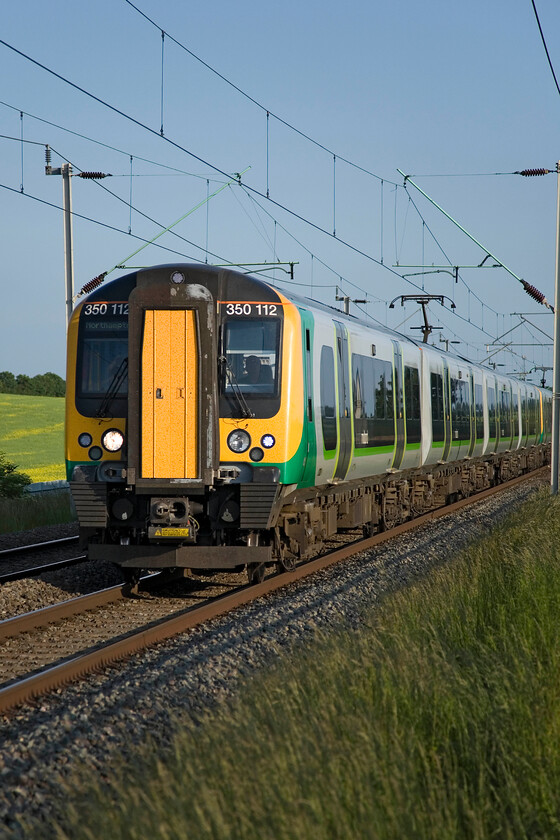 350112 LM, 18.05 London Euston-Crewe (2U91), Milton Malsor SP740553 
 Unfortunately, due to my elevated position on a ladder, I have managed to crop the rear of the 18.05 Euston to Crewe off! However, the lighting is so good at Milton Malsor that I have included the image of 350112. Crewe services usually bypass Northampton taking the Weedon route but in the morning and evening one train each way serves the town. 
 Keywords: 350112 18.05 London Euston-Crewe 2U91 Milton Malsor SP740553 London Midland desiro