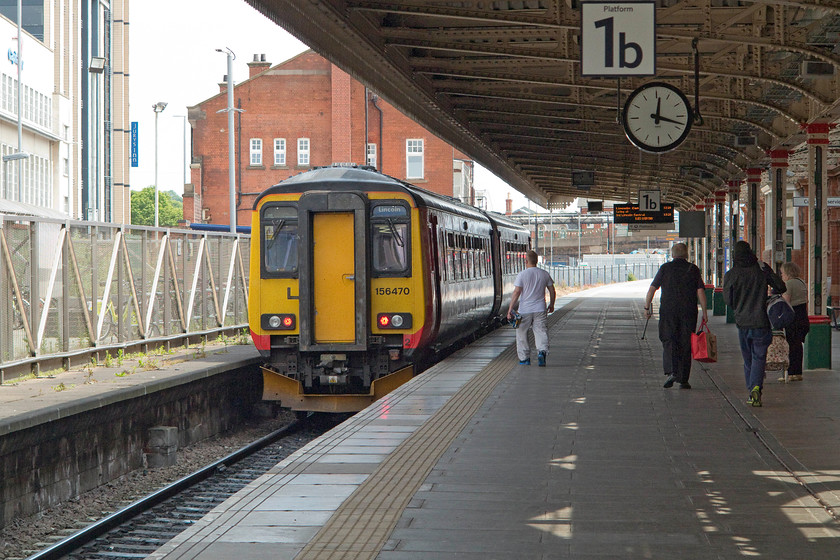 156470, EM 11.26 Leicester-Lincoln (2L67), Nottingham station 
 According to the station clock, 156470 has just arrived at Nottingham station with the 11.26 Leicester to Lincoln service due in at 12.14. It has a very generous dwell time not being due off until 12.29. 
 Keywords: 156470 11.26 Leicester-Lincoln 2L67 Nottingham station