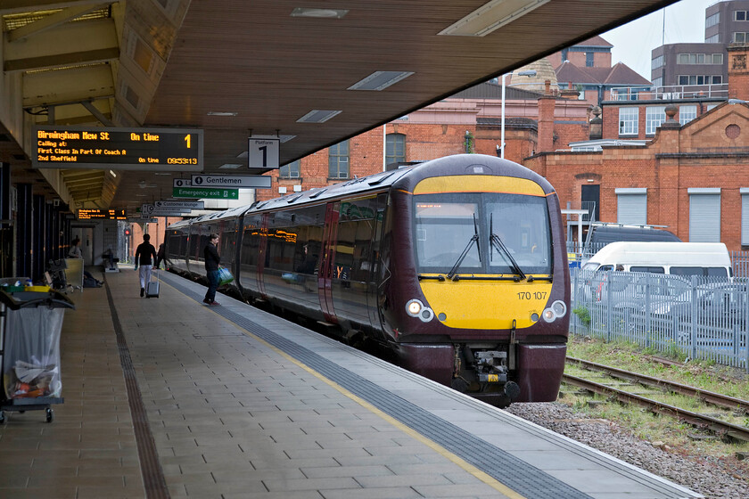 170107, XC 10.20 Leicester-Birmingham New Street (1P10), Leicester station 
 CrossCountry's 170107 waits at Leicester's platform one. As the station display screen indicates, it will soon work southwest as the 10.20 service to Birmingham New Street. The buildings in the background are largely former railway structures associated with the goods depot the sidings of which once occupied the large area now used for parking; an all to a common story, unfortunately. 
 Keywords: 170107 10.20 Leicester-Birmingham New Street 1P10 Leicester station Cross Country