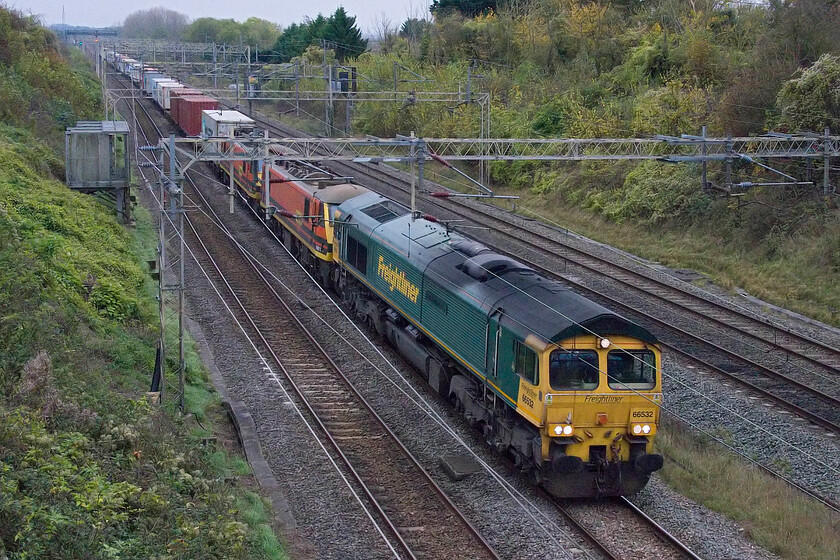 66532, 90013 & 90006, 09.32 Felixstowe North-Ditton (4M88, 69L), Victoria bridge 
 As the 4M88 09.32 Felixstowe to Ditton Freightliner was running to time as it past me at Victoria bridge near Roade I am not sure if there had been a problem with 90013 or 90006 'Roger Ford'. I suspect that they were removed at Crewe Basford Hall as this was where the heavy delay, later in the train's journey, set-in. 66532 P&O Nedlloyd Atlas is leading the train. 
 Keywords: 66532 90013 90006 09.32 Felixstowe North-Ditton 4M88 Victoria bridge Freightliner P&O Nedlloyd Atlas