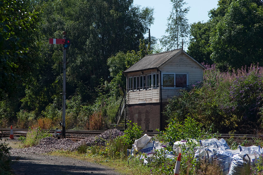 Little Mill Junction signal box (McK & H and GWR, c.1883) 
 When I last visited Little Mill Junction in 1985, the site was nothing like it is now! There were virtually no trees and the vista was completely open. This is as close as I dare get to the box to take my picture, there was no gate or fencing that was strange given the obsession that the modern railway has with security. Built in 1883 by McKenzie and Holland for the GWR, Little Mill is the first on the Marches line north from Newport. It has an NX panel for signalling and one lone semaphore, as seen in this picture, that controls the single line to the left. This siding is a remnant of the former branch line to Monmouth, that closed to passengers in 1955. The initial stub of the route is occasionally used by Network Rail engineering trains. 
 Keywords: Little Mill Junction signal box