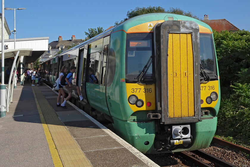 377316, SN 17.24 Seaford-Brighton (2C51, RT), Seaford station 
 Having spent a short time exploring Seaford and getting as far as the pebbly beach I walked back to the station in order to return to Brighton. I travelled on the 17.24 shuttle service running as 2C51, a journey of about thirty-five minutes. Electrostar 377316 basks in the summer sunshine at Seaford as passengers board. 
 Keywords: 377316 17.24 Seaford-Brighton 2C51 Seaford station Southern Electrostar