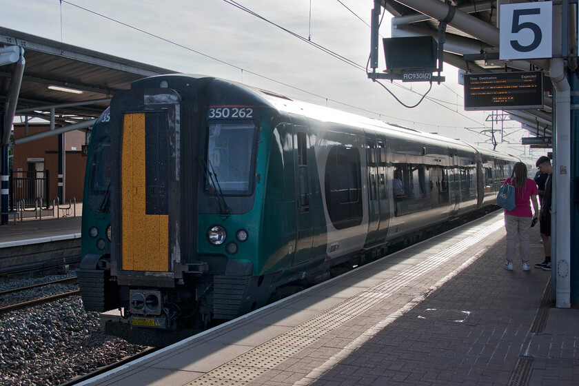 350262, LN 18.14 Birmingham New Street-London Euston (2Y42, 28L), Rugby station 
 The final train of our journey back from Crewe to Northampton arrives at Rugby's platform five. Mike and I travelled aboard 350262 working the 18.14 Birmingham New Street to London Euston train. This is not a great photograph as it is taken smack into the evening sunshine but it continues my tradition of photographing every train travelled on come what may! 
 Keywords: 350262 18.14 Birmingham New Street-London Euston 2Y42 Rugby station London Northwestern Desiro