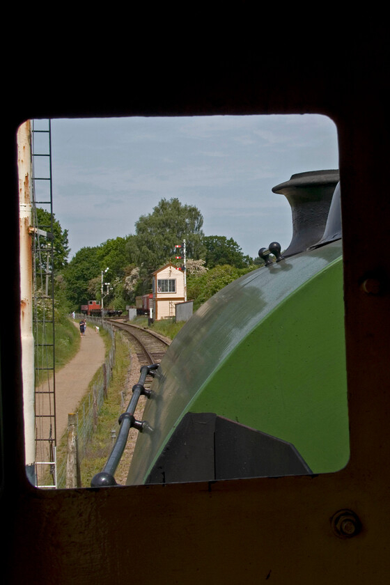 View from cab of No. 4, 12.00 Pitsford return 
 The view from the cab of Peckett 0-4-0 N0. 4 (2104) as it gets away from its limit of operation on the Northampton and Lamport Railway hauling the 12.00 Pitsford return service. The small signal box in the centre of the frame is named Pitsford Sidings and was previously located inside Wolverton Works. 
 Keywords: View from cab of No. 4 12.00 Pitsford return Peckett 0-4-0 2104