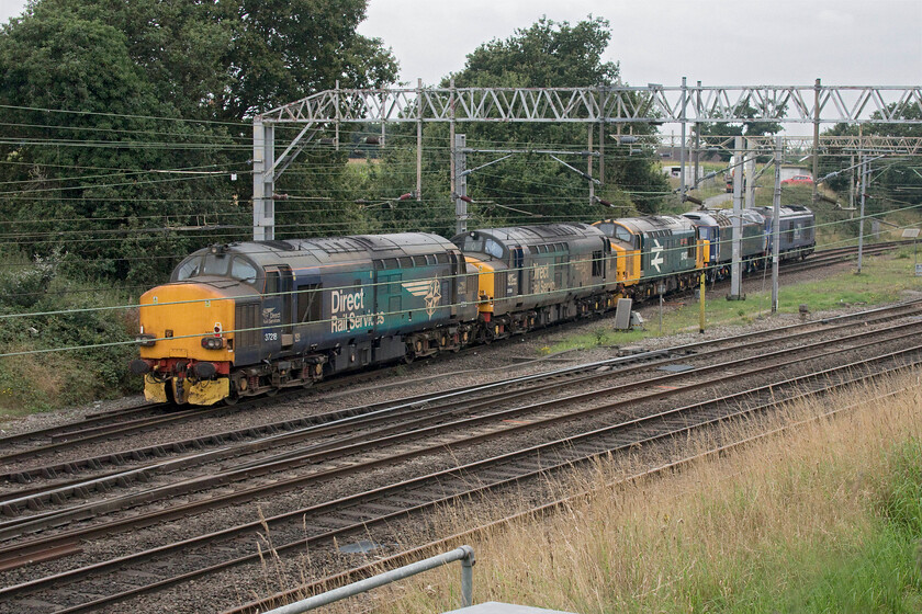 68007, 57303, 37407, 37038 & 37218, 09.12 Eastleigh Arlington-Gresty Bridge (0X39, 5E), Casey Lane SJ720519 
 Andy and I had been waiting around for this particular cavalcade to make its way past us here at Casey bridge at the southern access to Crewes Basford Hall. Running as 0X39 68007 Valiant leads 57303, 37407 Blackpool Tower, 37038 and 37218 into the huge yard complex to make their way to the far north-west side into the DRS depot. The locomotives had run from Eastleighs Arlington plant leaving at 09.12 giving fellow enthusiasts plenty of time to post on the various forums keeping the rest of us informed as to its progress. 
 Keywords: 68007 57303 37407 37038 37218 09.12 Eastleigh Arlington-Gresty Bridge 0X39 Casey Lane SJ720519 Valiant Blackpool Tower