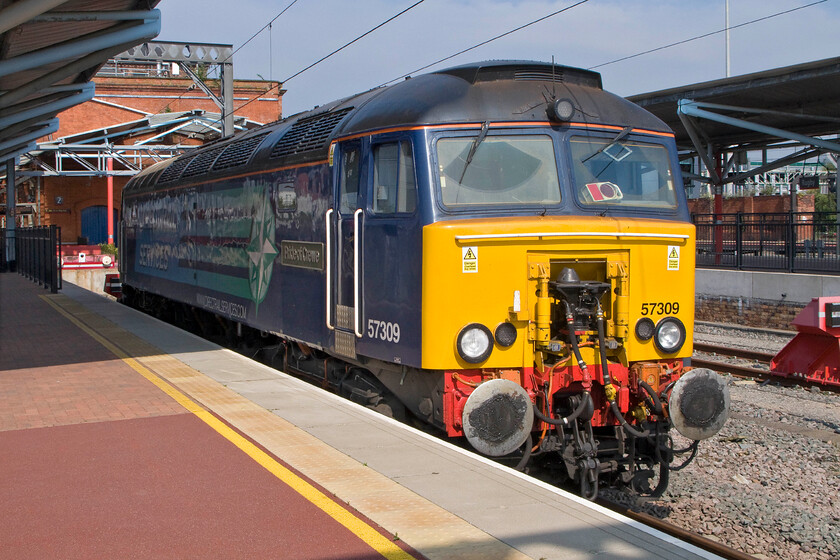 57309, stabled Thunderbird, Rugby station 
 57309 'Pride of Crewe' stands in one of Rugby's south-facing bay platforms ready to go if control receives the call from a stranded Virgin Train's driver. Thankfully, this does not happen very often with their fleet of Voyagers and Pendolinos being very reliable. 
 Keywords: 57309 stabled Thunderbird Rugby station Pride of Crewe DRS Direct Rail services