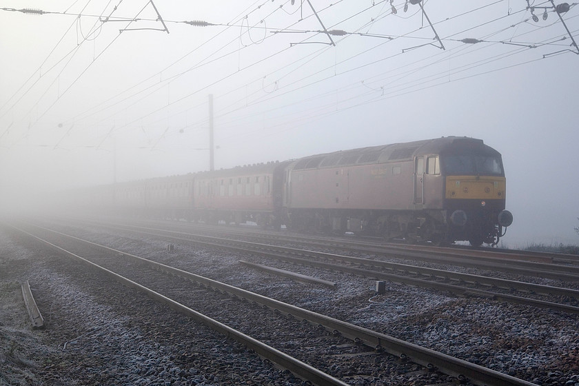 47804, outward leg of The York Yuletide Express, 07.11 Ealing Broadway-York (1Z10), Holme Green Crossing TL192426 
 This photograph was supposed to have been somewhat different! Rather than a drab West Coast Railways 47804 leading this charter past Holme Green crossing south of Biggleswade, it was supposed to have been A4 Pacific 60009 'Union of South Africa' but this had been declared a failure prior to departure from Ealing Broadway as the 07.11 to York. The passengers aboard The York Yuletide Express would no doubt have been disappointed at the lack of steam haulage on the outward leg of the journey but, hopefully, 6233 'Duchess of Sutherland' hauling the return working would have made up for the disappointment. 
 Keywords: 47804 The York Yuletide Express 07.11 Ealing Broadway-York 1Z10 Holme Green Crossing TL192426 West Coast Railways class 47 Duff 60009 Union of South Africa