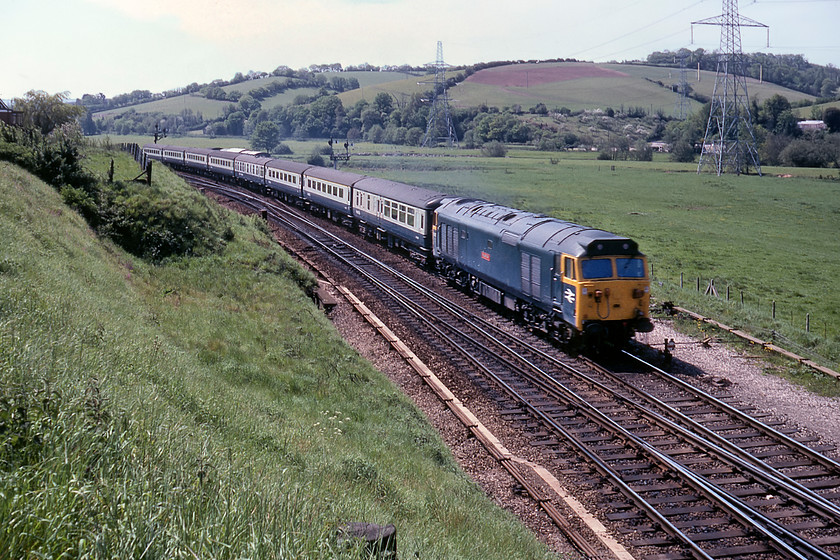 50017, 11.20 Paignton-London Paddington, Cowley Bridge Junction 
 By this time of day, this viewpoint at Cowley Bridge was becoming rather too backlit for my liking. However, the fine sight and sound of 50017 'Royal Oak' accelerating away from Exeter with the 11.20 Paignton to Paddington will have inspired me to press my shutter! 50017 was the third member of the class to be comprehensively refurbished, or re-built given the amount of work undertaken, and had been back in service for some three months when this photograph was taken. However, being an early refurbished example, it does not have its centre mounted high-intensity headlamp fitted but the hole to accept it is drilled and crudely plated over with a circular disk of steel. 
 Keywords: 50017 11.20 Paignton-London Paddington Cowley Bridge Junction Royal Oak