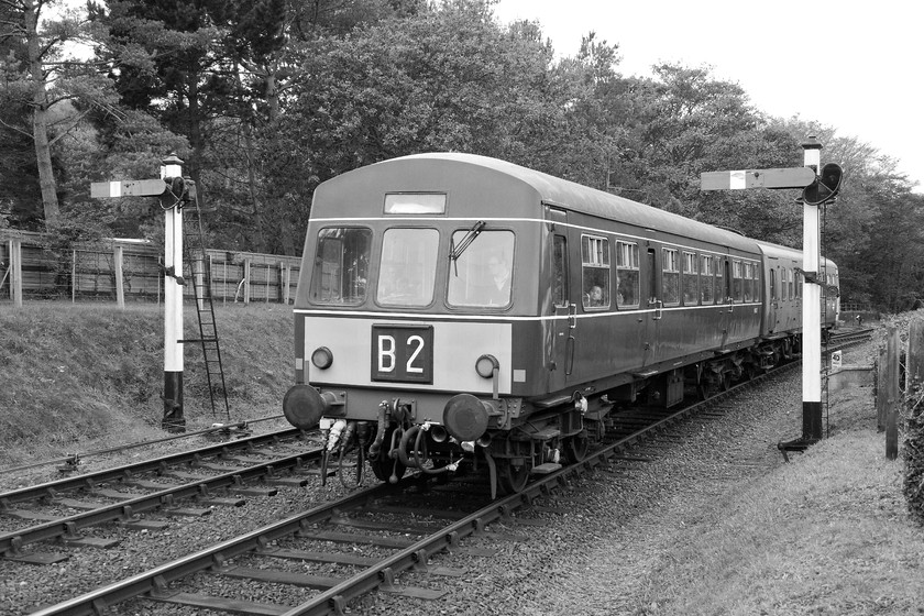 M56352 & M51188, 10.35 Holt-Sheringham, Weybourne station 
 A black and white image has really aged this image nicely on the approach to Weybourne station. It shows M56352 and M51188 arriving working the 10.35 Holt to Sheringham service. Both the signals here are ex. GE wooden somersault examples that make a great noise when they are operated. 
 Keywords: M56352 M51188 10.35 Holt-Sheringham Weybourne station