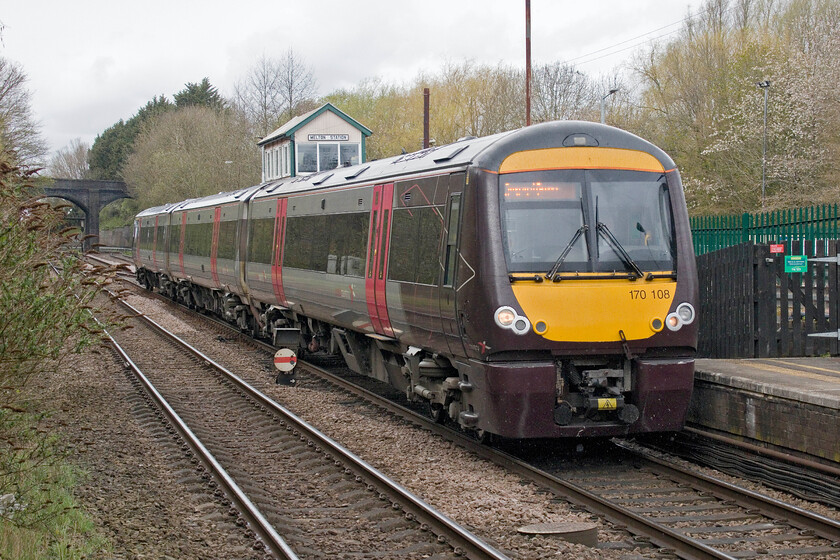 170108, XC 10.22 Birmingham New Street-Stansted Airport (1L36, 3E), Melton Mowbray station 
 In the rain again but this time at Melton Mowbray station sees CrossCountrys 10.22 Birmingham New Street to Stansted Airport service arrive worked by 170108. Melton Stations LMS 1942 signal box can be seen towering above the train that I photographed from another angle and an unofficial spot back in 1981, see. https://www.ontheupfast.com/p/21936chg/30036330555/melton-station-signal-box-lms-london 
 Keywords: 170108 10.22 Birmingham New Street-Stansted Airport 1L36 Melton Mowbray station CrossCountry XC Turbo