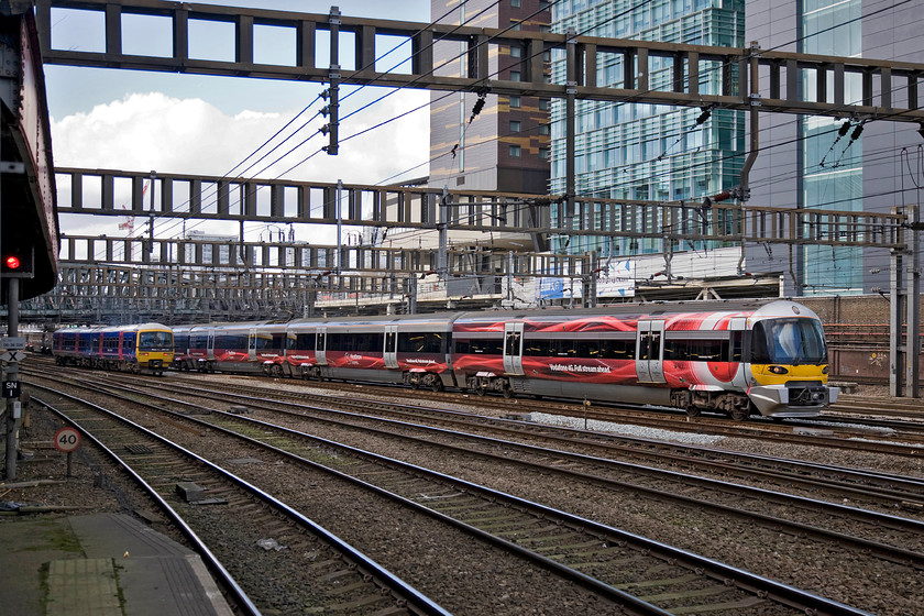 165134, GW 13.18 London Paddington-Great Bedwyn (1K60) & 332007, HX 12.57 Heathrow-London Paddington (1Y53), London Paddington station 
 In the throat of Paddington station 165134 gests away with the 1K60 13.18 to Great Bedwyn. Meanwhile, looking smart in its Vodafone 4G livery Heathrow Express' 332007 arrives with the 12.57 from Heathrow terminal four. Northern Rail operates some very similar units classified as Class 333s with HX operating just thirteen 332 sets configured in either four (nine sets of) of five (five sets of) cars. 
 Keywords: 165134 13.18 London Paddington-Great Bedwyn 1K60 332007 12.57 Heathrow-London Paddington 1Y53 London Paddington station Heathrow Express First Great Western Turbo unit