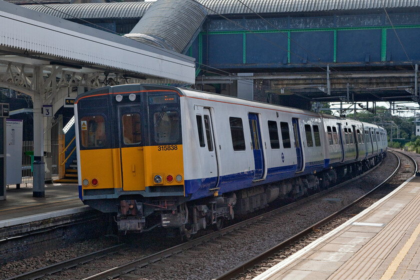 313838 & 313857, TF 15.56 Shenfield-London Liverpool Street (2W03, RT), Brentwood station 
 The veteran Class 313 EMUs have been in operation for some forty years now and I think that it's safe to say that the railways have had pretty good value out of the BREL (York) units! However, the remaining sets will not be about for much longer with about half now having already been scrapped. 313838 and 313857 leave Brentwood station working the 15.56 Shenfield to Liverpool street a remaining journey distance of eighteen miles. 
 Keywords: 313838 313857 15.56 Shenfield-London Liverpool Street 2W03 Brentwood station TfL Rail