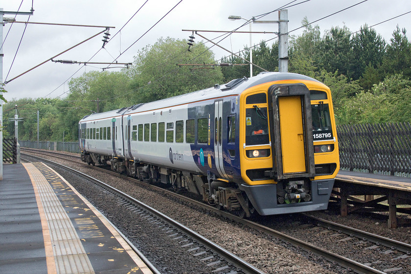 158795, NT 10.29 Leeds-Knottingley (2A11, 2E), Outwood station 
 Northern's 158795 passes through Outwood station working the 10.29 Leeds to Knottingley service. Despite their awful reputation, for so many reasons not to go into now, Northern's new livery is smart and keeps these relatively elderly units, dating from around 1990, looking modern. 
 Keywords: 158795 10.29 Leeds-Knottingley 2A11 Outwood station Northern