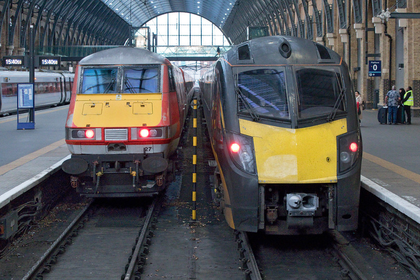 82227, GR 16.05 London King`s Cross-Leeds (1D21, RT) & 180112, GC 15.50 London King`s Cross-Bradford Interchange (1D93, 1L), London King`s Cross station 
 Platforms one and two at King's Cross are occupied by two services heading for northern cities just a few miles adjacent to each other. To the left, 82227 will be at the rear of the LNER 16.05 to Leeds whilst, to the right Grand Central's 180112 will soon leave with the 15.50 to Bradford Interchange. Over on platform three, a Class 800 Azuma will also work north, out of all these three trains, the Mk. IV stock would be my favourite any day! 
 Keywords: 82227 16.05 London King`s Cross-Leeds 1D21 180112 15.50 London King`s Cross-Bradford Interchange 1D93 London King`s Cross station LNER Mk. IV DVT Grand Central