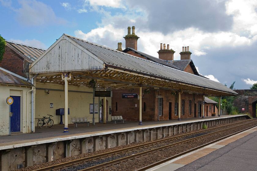 Annan station 
 Like the GSW signal box at Annan (seen in the previous photograph) the station is also Category B listed by Historic Scotland. However, from this view, the canopy on the up platform looks in need of some attention! The main station and frontage are a different matter with Historic Scotland describing in its citation (Annan station) 'a particularly fine and well-detailed, Italianate influenced, mid-19th-century railway station in the South West region of Scotland'. They go on to say 'The ordered composition and massing of the building and use of good quality sandstone ashlar and other materials mark it out as an example within its building type.' 
 Keywords: Annan station