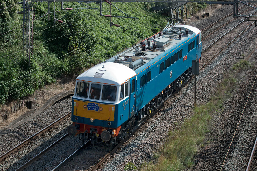 86259, 12.11 Acton Lane Reception sidings-Rugby CS (0Z88, 3E), Victoria bridge 
 86259 'Les Ross/Peter Pan' runs as the 0Z88 light engine through the sunny Northamptonshire countryside just south of Roade. Having worked the outward and return leg of The Cumbrian Mountain Express the previous day it is returning to its base just to the north of Rugby station in some somewhat overgrown sidings as the 12.11 ex Acton Lane Reception Sidings. 
 Keywords: 86259 12.11 Acton Lane Reception sidings-Rugby CS 0Z88 Victoria bridge Les Ross Peter Pan