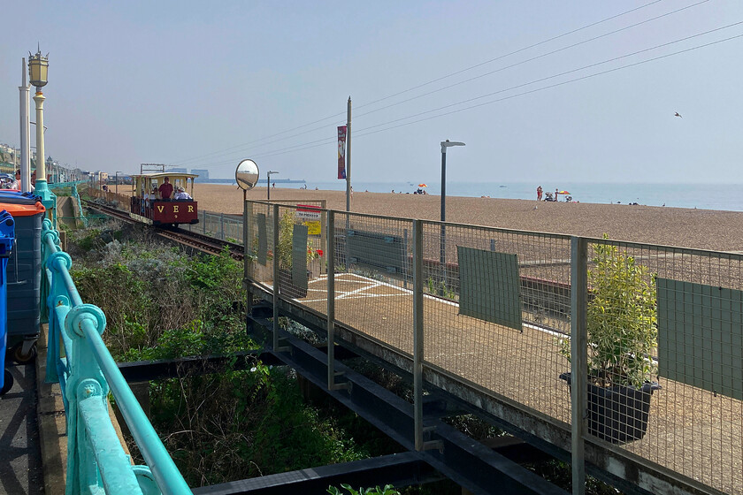 No. 9, Black Rock-Aquaium working, Aquaium station 
 Under a cloudless late summer sky, with temperatures to match, Brighton's Seafront looks inviting but of more interest to me is the Volk's Electric Railway (VER)! The VER is the oldest operational electric railway in the world having opened in the summer of 1883. Apart from a few breaks in operation, it has been carrying passengers along the eastern side of Brighton Seafront for the past one hundred and forty years. Car number 9 is seen approaching the western terminus known as Aquarium station. The line runs for just over a mile with the eastern terminus just short of Brighton Marina which is seen in the distance just above the car. 
 Keywords: No. 9 Black Rock-Aquarium Aquarium station VER Volk's Electric Railway