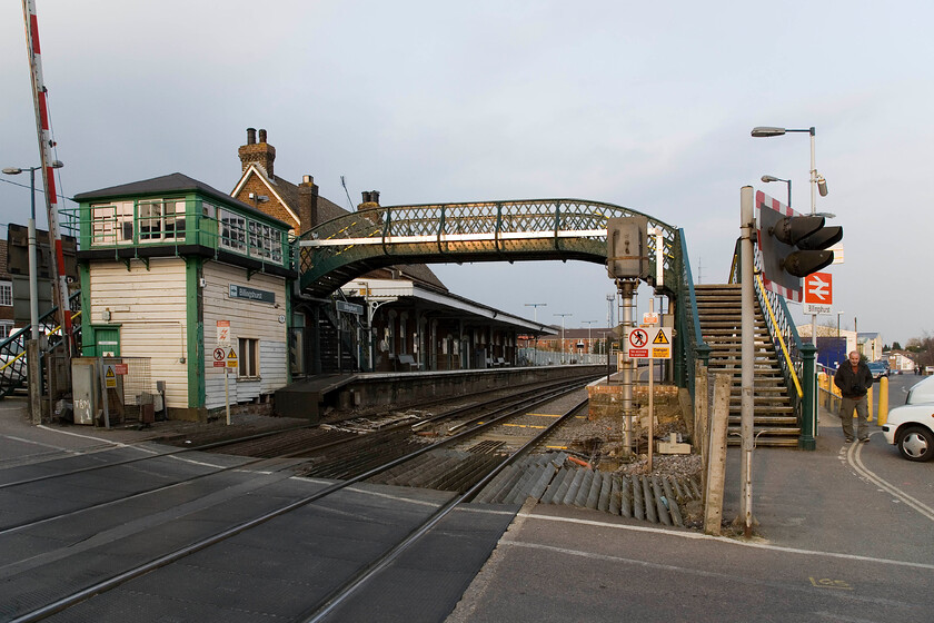 Billingshurst station, level crossing & signal box (LBSC, 1876) 
 Apart from the modern signage Billingshurst station is a potential modeller's delight! With its superb 1876 LBSC signal box (now operating on limited time), its lattice footbridge and classic LBSC station (even though it was actually built by the Mid-Sussex Railway in 1859) complete with its ornate barge boarding to the canopy. Andy is seen to the right about to nip across the road to the adjacent chip shop to buy us some well-earned dinner before we head on to our final two stations of the day! 
 Keywords: Billingshurst station level crossing signal box LBSC 1876