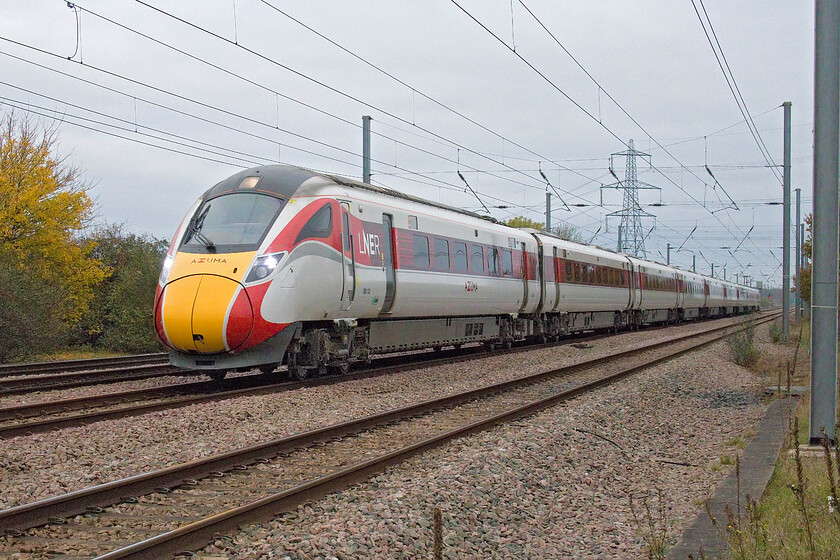 800102, GR 06.47 Leeds-London King's Cross (1A06, 14L), Tempsford level crossing 
 The section of the ECML from just north of Sandy to Little Barford is dead straight and makes an impressive site when viewed north or south from the level crossing at Tempsford just behind me. 800102 takes full advantage of this straight-as-a-die section of track at speed working the 06.47 Leeds to King's Cross service. 
 Keywords: 800102 06.47 Leeds-London King's Cross 1A06 Tempsford level crossing LNER Azuma