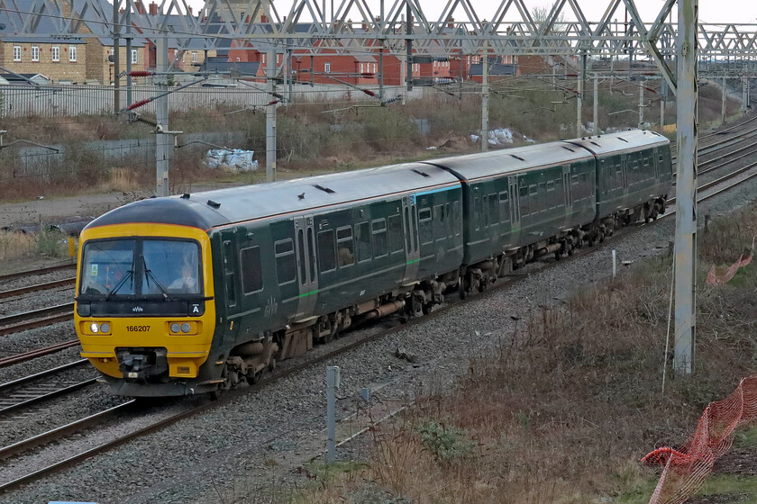 166207, 10.55 St. Philip's Marsh HST Depot-Doncaster Works Wagon Shops (5Q23, 6L), site of Roade station 
 A photograph that will have disappointed any photographers in the Northampton area who had gone out to capture the passage of the GWR Turbo unit a long way from its usual haunts. It was scheduled to take the Northampton loop but for some reason was pathed via Weedon thus avoiding the town. 166207 passes Roade as the 5Q23 10.55 St. Philip's Marsh HST Depot (Bristol) to Doncaster Works. I am not sure as to what work is been undertaken on these Turbo units at The Plant but I hope to see some more passing my way. Incidentally, the last time I captured this unit was two years ago in its more usual operating area, see..... https://www.ontheupfast.com/p/21936chg/30025381055/x166207-08-45-great-malvern-westbury but then it was wearing its previous FGW livery. 
 Keywords: 166207 10.55 St. Philip's Marsh HST Depot-Doncaster Works Wagon Shops 5Q23 site of Roade station GWR Turbo