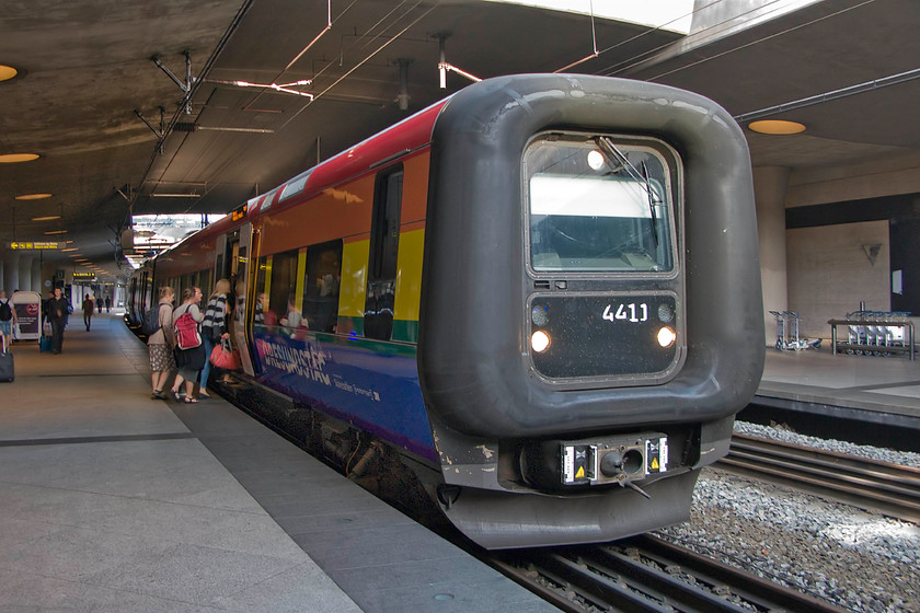 4411, 07.32 Copenhagen Central-Gteborg Central, Copenhagen Airport-station 
 Jointly operated and run by DSB and SJ (Danish and Sweedish Railways) Class Et set 4411 pauses at Copenhagen Airport station. It is forming the 07.32 Copenhagen Central to Gteborg Central that will shortly cross resund strait on the seven-point five miles fixed link. Initially, it will plunge into the Drogden Tunnel to emerge on to the artificial island of Peberholm and finally complete the crossing into Sweeden on the impressive resund bridge. During this journey it will change voltage from a 25Kv to a 15Kv system, enter a new signalling system and change from running on the left to the right. Unfortunately, my wife, son and I were not able to experience this as we had just alighted from this train as the first leg of our journey home to the UK marking the end of a great holiday! 
 Keywords: 4411 07.32 Copenhagen Central-Gteborg Central Copenhagen Airport-station Class ET resund strait Drogden Tunnel artificial island Peberholm