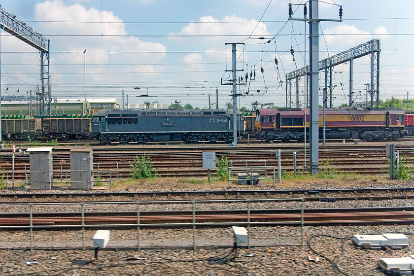 56312 & 66182, stabled, Wembley Yard 
 56312 'Jeremiah Dixon, Son of County Durham, Surveyor of the Mason - Dixon Line USA' and 66182 sit stabled in Wembley Yard awaiting their next turn. The 56 was built as 56003 being one of the early Romanian locomotives. After withdrawal it ended up at the Gloucestershire and Warwickshire Railway. It then moved to the Nene valley railway for an overhaul and was operated by Hanson Traction and was renumbered 56312. It is now a DC branded loco. and looking for work! 
 Keywords: 56312 66182 Wembley Yard