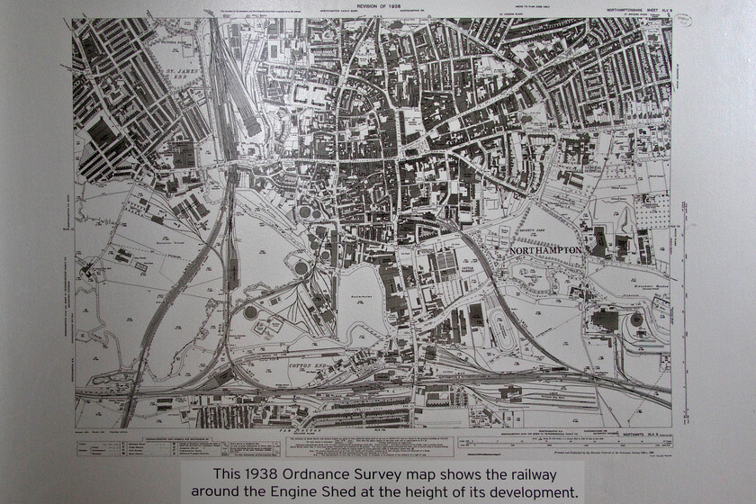 Information map, The Engine Shed, Students' Union building, UON Riverside campus 
 Probably ignored by the students were a number of extremely interesting boards located around the central hub in the Student Union building at UON's Riverside campus. These boards gave a very detailed history of their SU building from its construction in 1872 by the Midland Railway until its reopening in 2018. One of the items on display is this superb reproduction of an Ordnance Survey map of Northampton dated 1938. It reveals the complexity of railway routes in the town that existed then in stark contrast to today's situation. The Midland engine shed in which I am standing is located clearly in the lower right-hand corner as the dark black rectangle at what was called Hardingstone Junction where the Midland spur leading to the now-closed St. John's station splits off from the Peterborough line. 
 Keywords: Information map The Engine Shed, Students' Union building UON Riverside campus