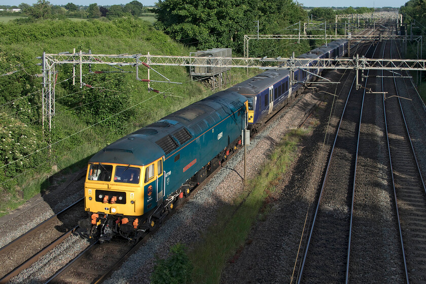 47749 & 360119, 15.29 Cricklewood South Sidings-Northampton EMD (5Q98, 1E), Victoria bridge 
 What a waste of energy but I am sure there are reasons for it that I do not understand! EMR's 360119 is towed from Cricklewood to Northampton's King's Heath depot for maintenance of some kind. Quite why it is being towed by GBRf's 47749 'City of Truro' and not under its own power I am not sure as this is a regular drag operation; advice anybody? It's an interesting thought that the line that the EMR unit operates on is just thirteen miles away to the east from this spot just south of Roade but despite this, the unit is dragged over sixty-five miles from the north London depot! Why not simply drag it from Bedford to Bletchley via the Marston Vale line and then head north to Northampton....too easy I suppose? 
 Keywords: 47749 360119 15.29 Cricklewood South Sidings-Northampton EMD 5Q98 Victoria bridge EMR East Midlands Railway City of Truro