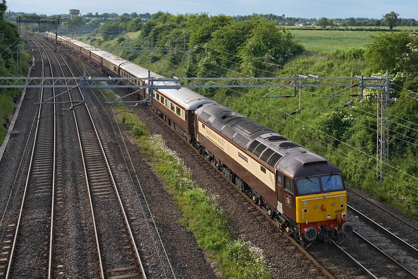 47832, Willesden Yard-Milton Keynes Central-Northampton-Birmingham New Street Silverstone GP Special (1Z36), Victoria bridge 
 47832 'Solway Princess' looks smart in its Northern Belle that matches the stock as it passes Victoria bridge between the Northamptonshire villages of Roade and Ashton. It is bringing up the rear of the British Grand Prix charter that will collect passengers at Northampton who will have been brought from Silverstone by special busses. They will then take an extended return trip to London via Birmingham New Street enjoying a sumptuous dinner en route. 
 Keywords: 47832 Willesden Yard-Milton Keynes Central-Northampton-Birmingham New Street Silverstone GP Special 1Z36 Victoria bridge Solway Princess